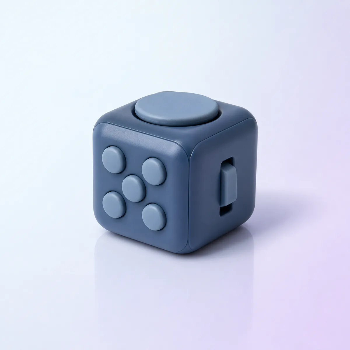 Click-Cube Focus Fidget: slate cube with buttons, dial and switch on a soft pastel background
