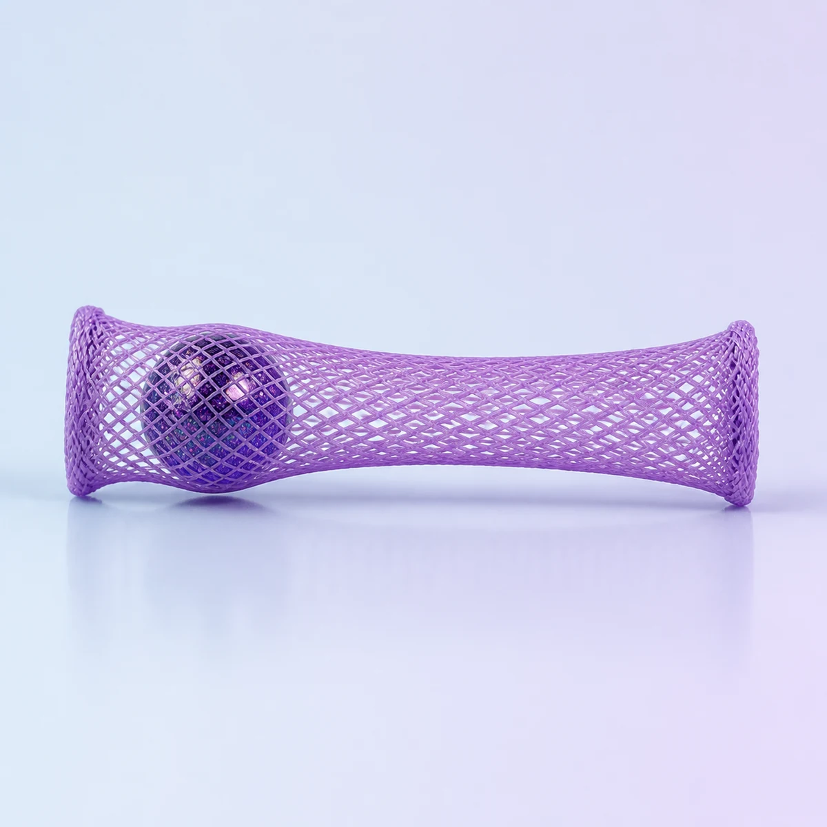 Roll and Squeeze Mesh Marble Fidget: galaxy-purple marble inside a lavender mesh tube on a soft pastel background